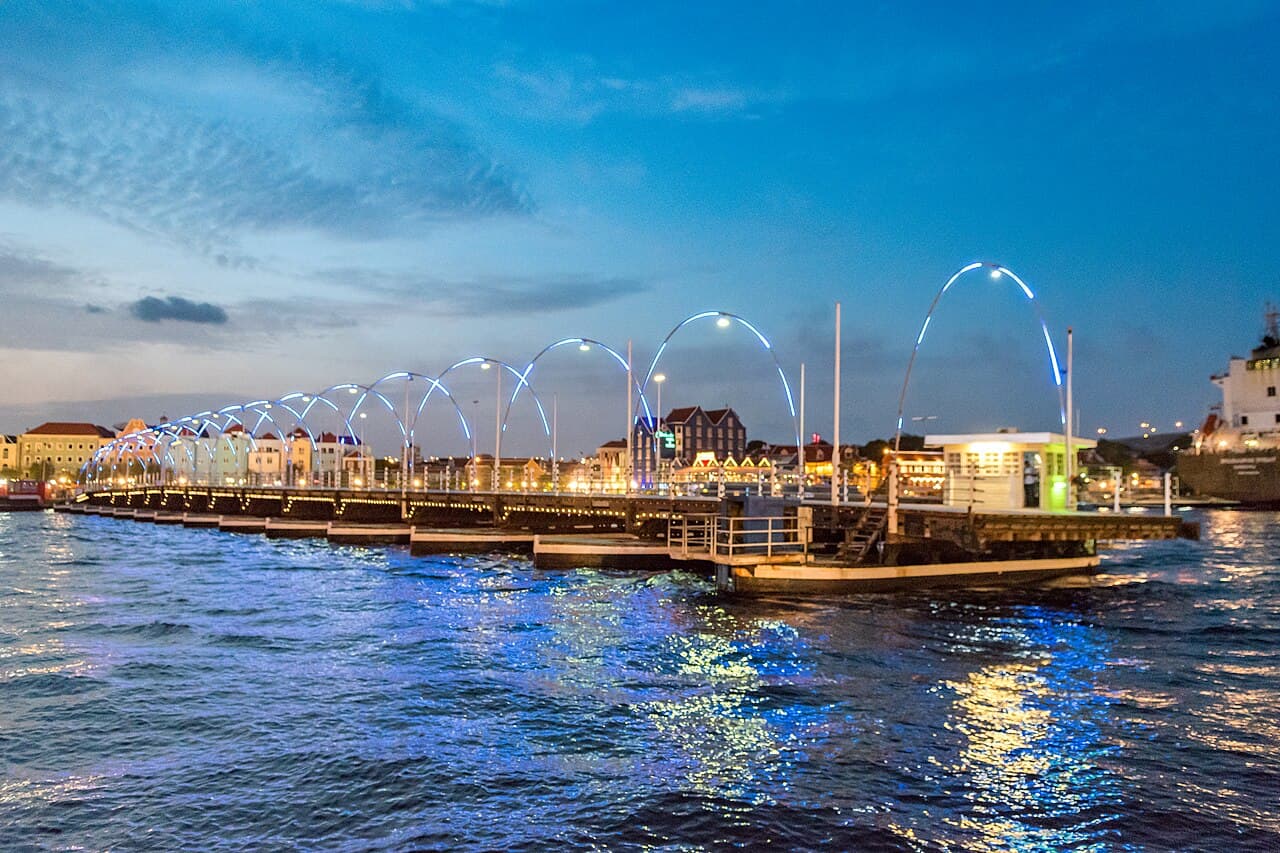 Willemstad waterfront and Queen Emma Bridge lit up at night, Curaçao